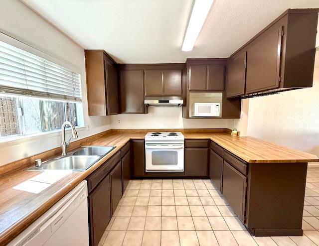 80 Portola Way Unit 105, Tracy, CA 95376 - kitchen featuring under cabinet range hood, white appliances, a sink, and light tile patterned floors