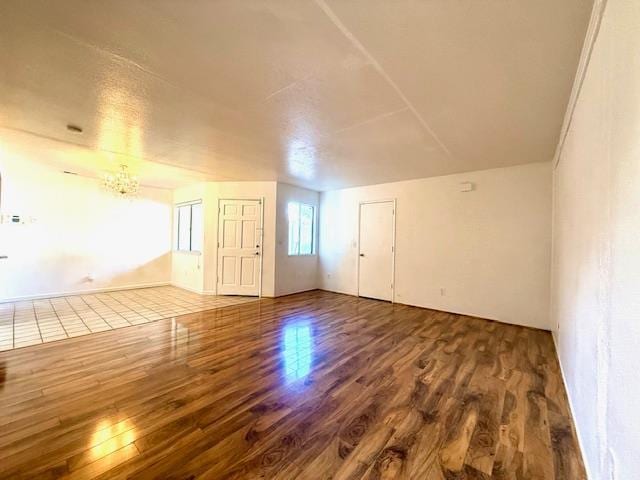 80 Portola Way Unit 105, Tracy, CA 95376 - unfurnished living room with wood finished floors and a chandelier