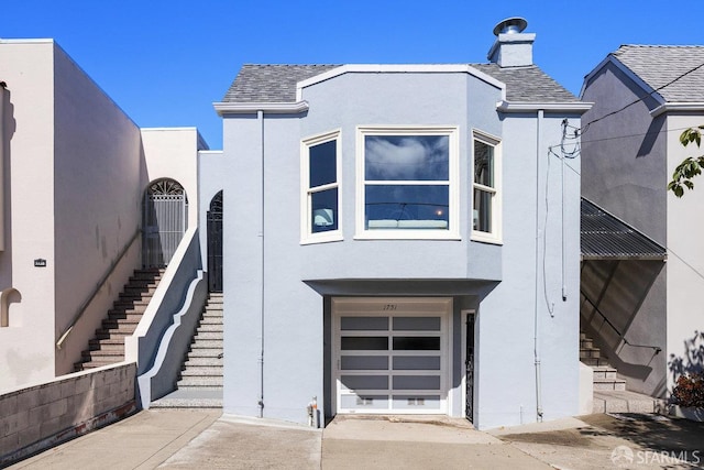1751 25th Ave, San Francisco, CA 94122 - view of front of house with stucco siding, a garage, and stairs