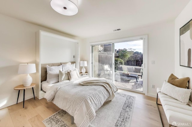 bedroom with light hardwood / wood-style flooring and access to outside