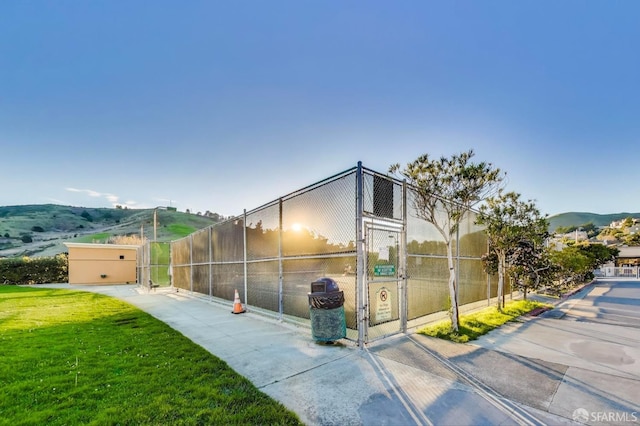 view of home's exterior with a mountain view and a yard