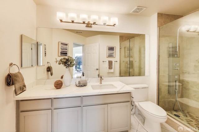 bathroom with an enclosed shower, vanity, and toilet