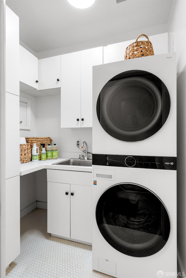 49 Hill St, San Francisco, CA 94110 - laundry area featuring stacked washer and clothes dryer and cabinet space