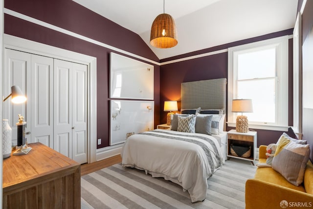 49 Hill St, San Francisco, CA 94110 - bedroom with vaulted ceiling, a closet, and light wood-type flooring