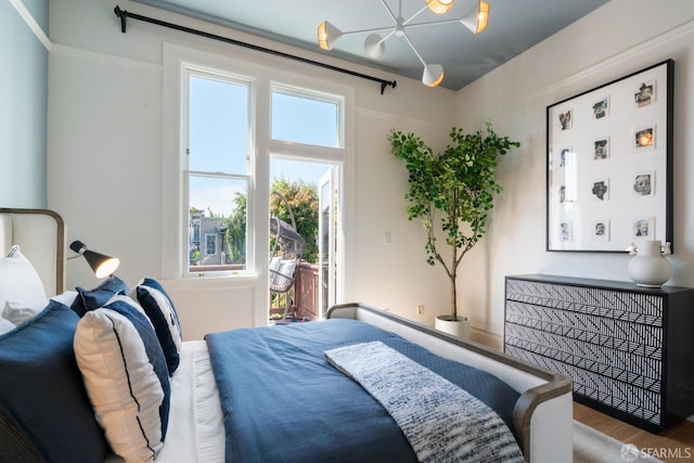 49 Hill St, San Francisco, CA 94110 - bedroom featuring a chandelier, access to outside, and wood finished floors