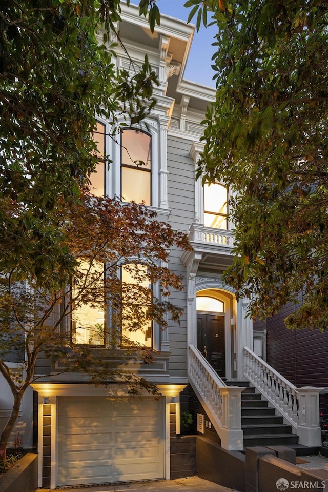 49 Hill St, San Francisco, CA 94110 - view of front of house featuring an attached garage, stairs, and a balcony