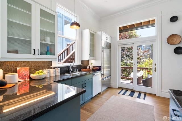 49 Hill St, San Francisco, CA 94110 - kitchen featuring dishwasher, white cabinetry, pendant lighting, light wood-style floors, and ornamental molding