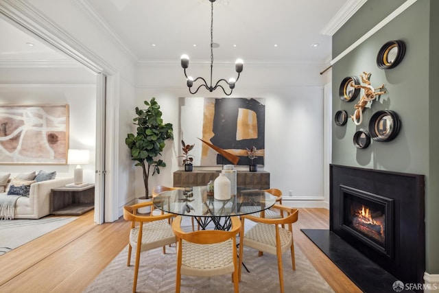 49 Hill St, San Francisco, CA 94110 - dining area featuring wood finished floors, a chandelier, a glass covered fireplace, and ornamental molding