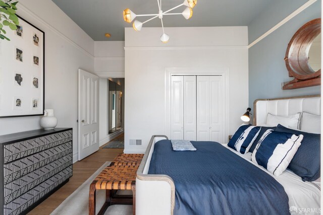 49 Hill St, San Francisco, CA 94110 - bedroom with a chandelier, wood finished floors, and a closet