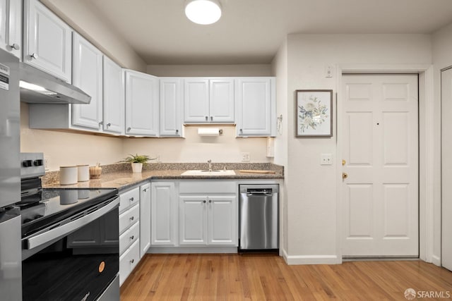 kitchen with white cabinets, sink, appliances with stainless steel finishes, and light hardwood / wood-style floors