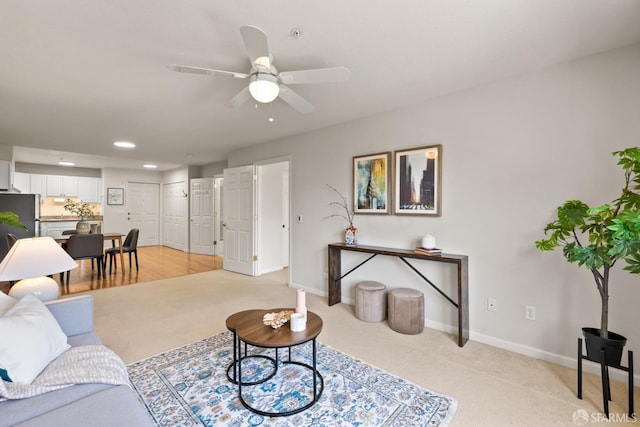 carpeted living room with ceiling fan