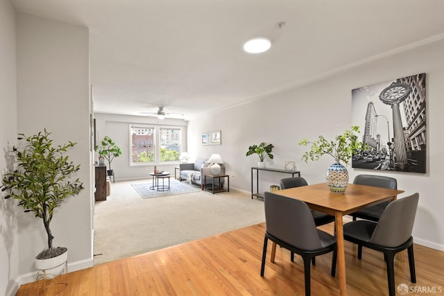 dining space with ceiling fan and hardwood / wood-style flooring