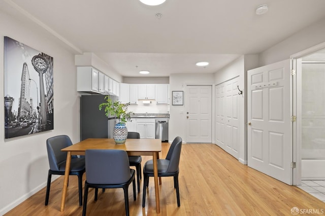 dining space with light hardwood / wood-style flooring