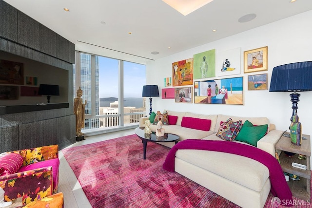 living room featuring wood-type flooring and expansive windows