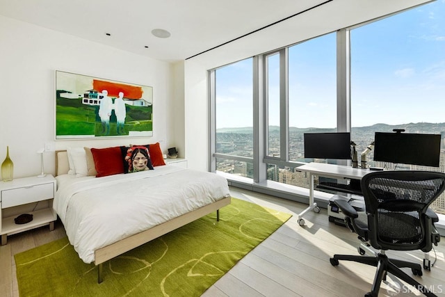 bedroom with hardwood / wood-style floors