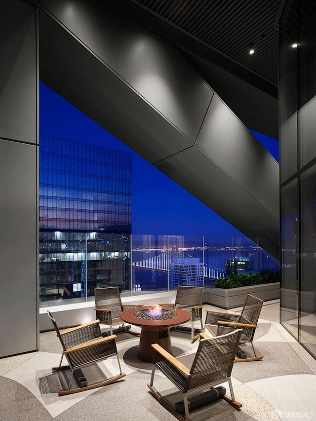 patio at twilight with an outdoor living space with a fire pit