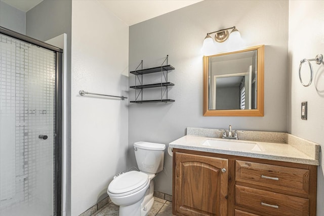 bathroom featuring tile patterned floors, vanity, toilet, and a shower with shower door