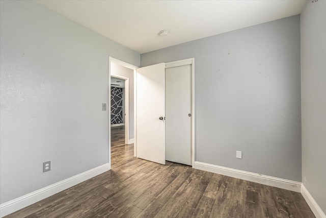 spare room with dark wood-type flooring