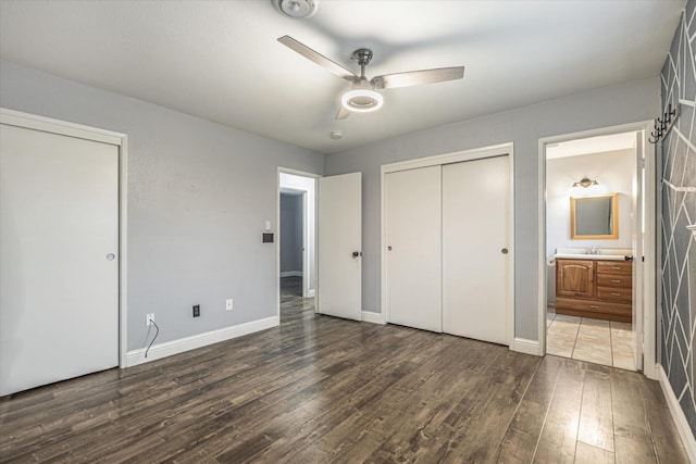 unfurnished bedroom with dark hardwood / wood-style floors, ensuite bath, ceiling fan, and sink