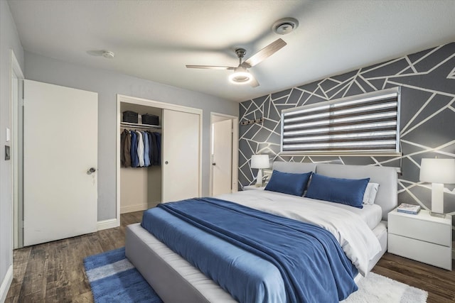 bedroom with a textured ceiling, a closet, ceiling fan, and dark wood-type flooring