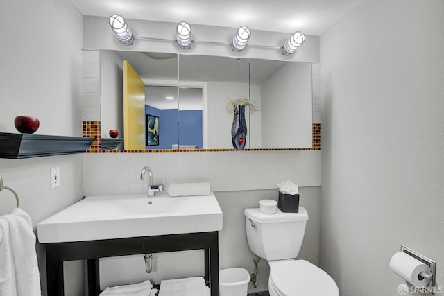 bathroom with tasteful backsplash and toilet