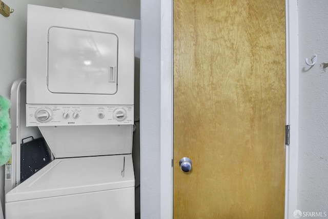 laundry area featuring stacked washing maching and dryer and laundry area