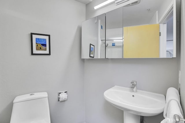 bathroom featuring toilet and a sink