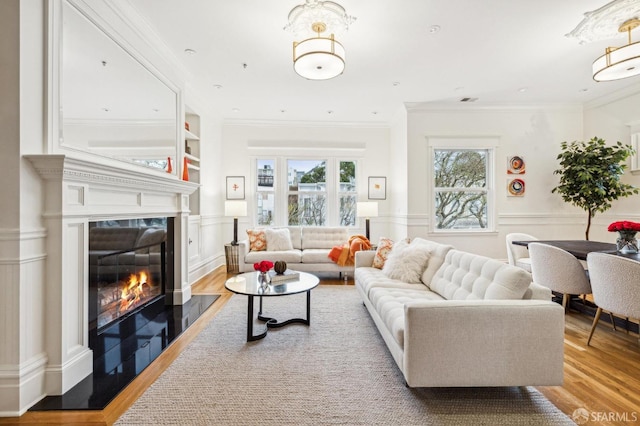 living room featuring crown molding and light hardwood / wood-style floors