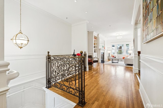 hall with crown molding and hardwood / wood-style flooring