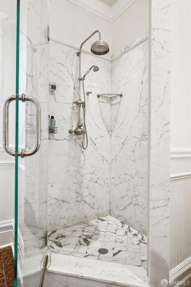 bathroom featuring crown molding and a shower with door