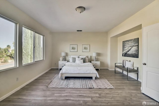 bedroom featuring wood finished floors and baseboards