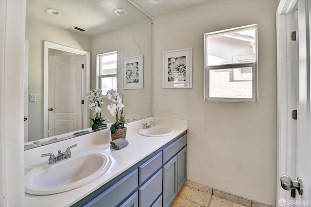 bathroom with recessed lighting, visible vents, a sink, and double vanity