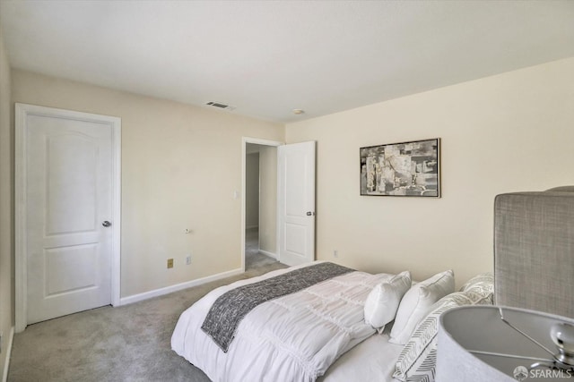 carpeted bedroom with visible vents and baseboards