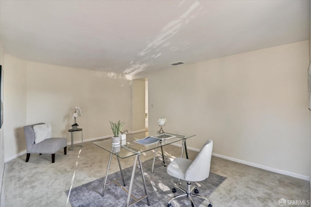 carpeted office featuring visible vents and baseboards