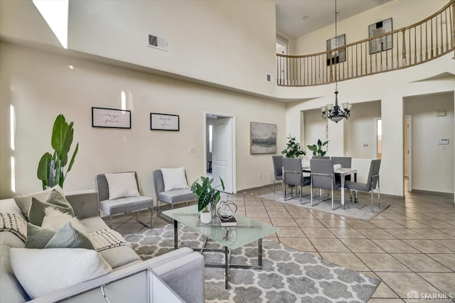 living room featuring a chandelier, visible vents, baseboards, and light tile patterned floors