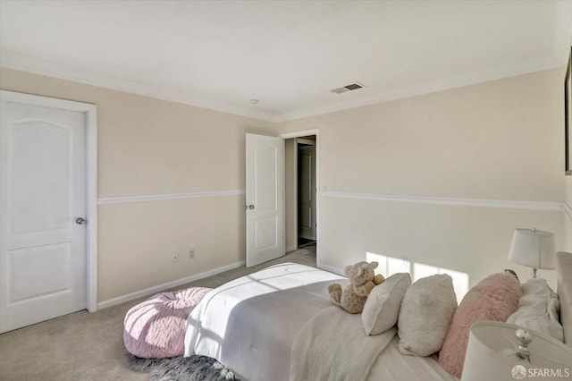 carpeted bedroom featuring baseboards, visible vents, and ornamental molding