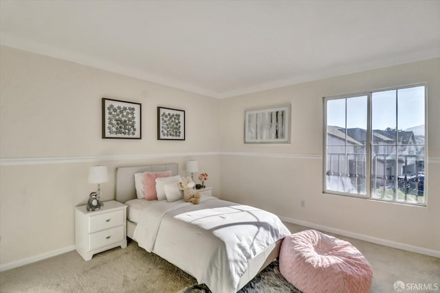 bedroom with light carpet and baseboards