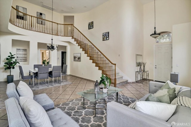 tiled living room with stairway and a notable chandelier