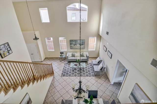 tiled living area with a high ceiling