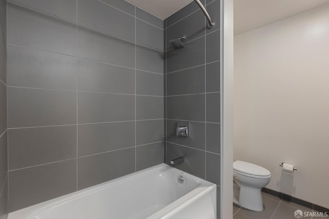 bathroom with toilet, tile patterned flooring, and shower / washtub combination