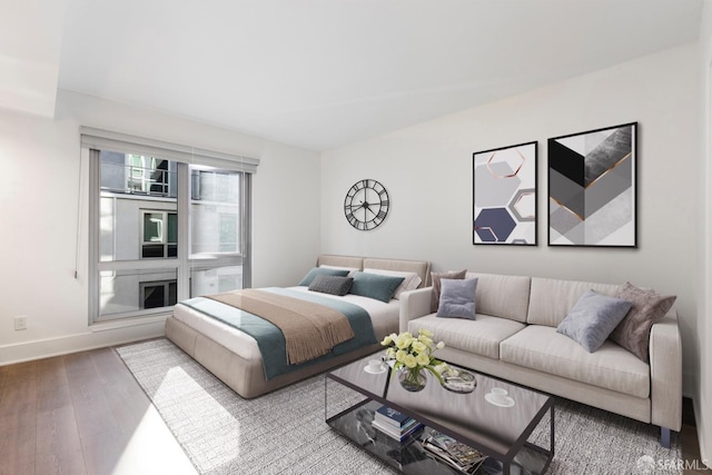 bedroom with baseboards and wood finished floors