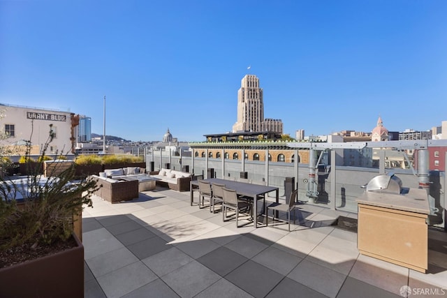 view of patio / terrace with an outdoor living space and a city view