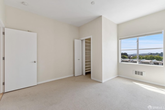 1600 Webster St Unit 409, San Francisco, CA 94115 - unfurnished bedroom with a walk in closet, carpet flooring, baseboards, and visible vents