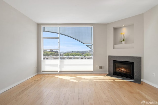 1600 Webster St Unit 409, San Francisco, CA 94115 - unfurnished living room featuring a fireplace with flush hearth, visible vents, baseboards, and hardwood / wood-style floors