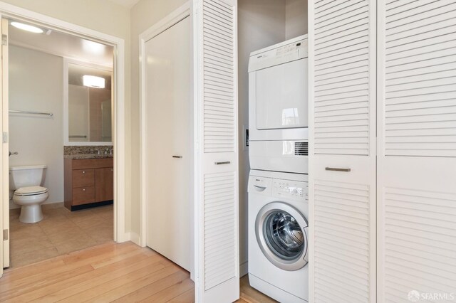 1600 Webster St Unit 409, San Francisco, CA 94115 - laundry area with stacked washer and dryer, light wood finished floors, and laundry area