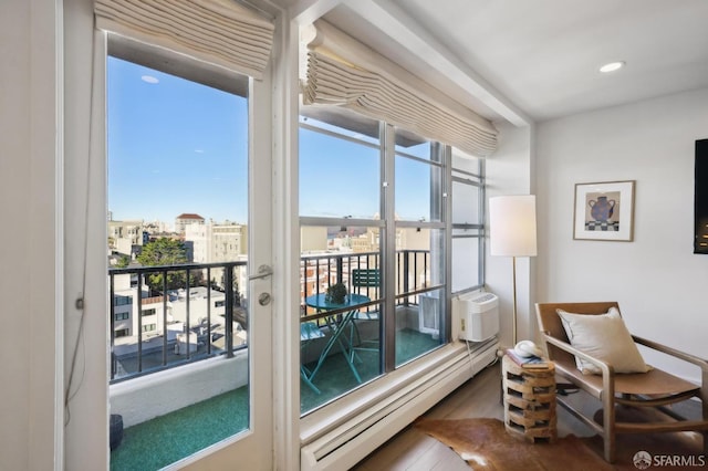 entryway with hardwood / wood-style flooring, cooling unit, and a baseboard heating unit