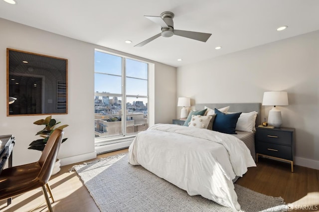 bedroom with ceiling fan and dark hardwood / wood-style flooring