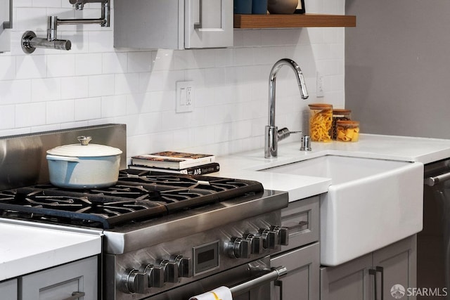 1 Rausch St Unit A, San Francisco, CA 94103 - kitchen featuring high end range, gray cabinetry, decorative backsplash, and light countertops