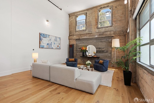 1 Rausch St Unit A, San Francisco, CA 94103 - living room featuring hardwood / wood-style floors, a towering ceiling, and a fireplace