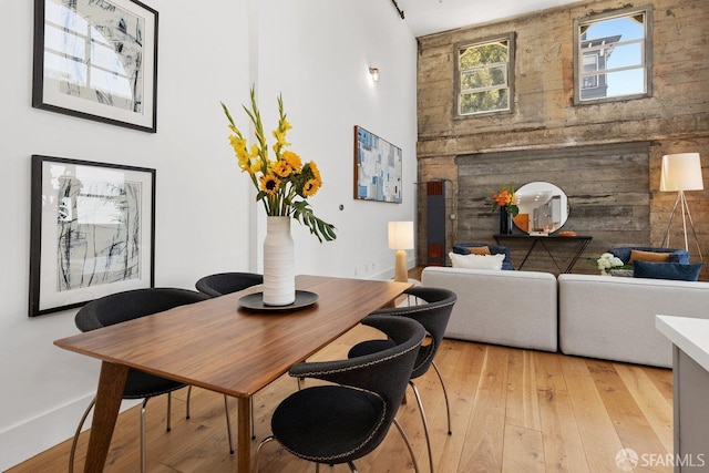 1 Rausch St Unit A, San Francisco, CA 94103 - dining space with a towering ceiling, light wood-type flooring, and a fireplace